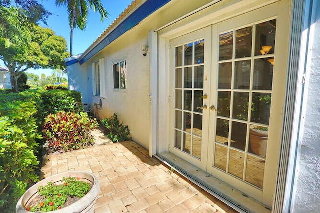 view of side of home featuring french doors and a patio area