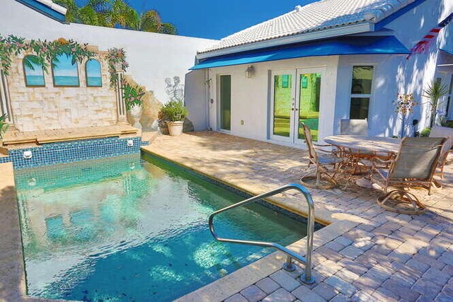 rear view of house with a patio area and french doors