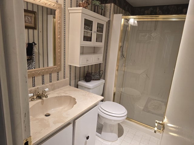 bathroom featuring tile patterned flooring, vanity, toilet, and walk in shower