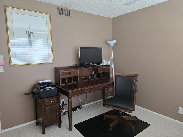 office space featuring a textured ceiling and light colored carpet