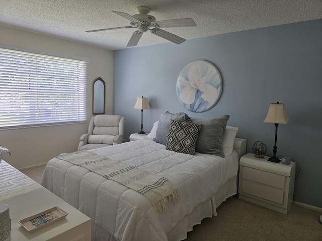 carpeted bedroom featuring a textured ceiling and ceiling fan