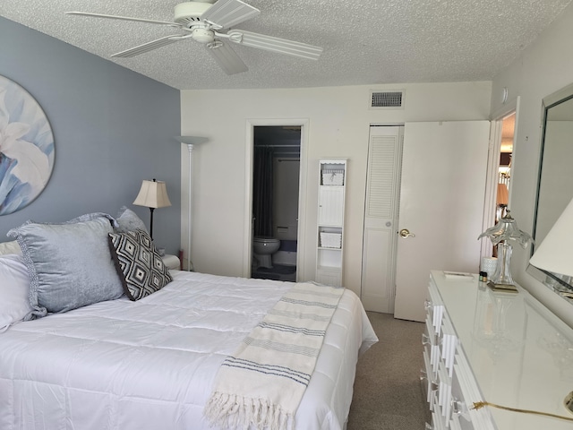 carpeted bedroom with connected bathroom, ceiling fan, and a textured ceiling