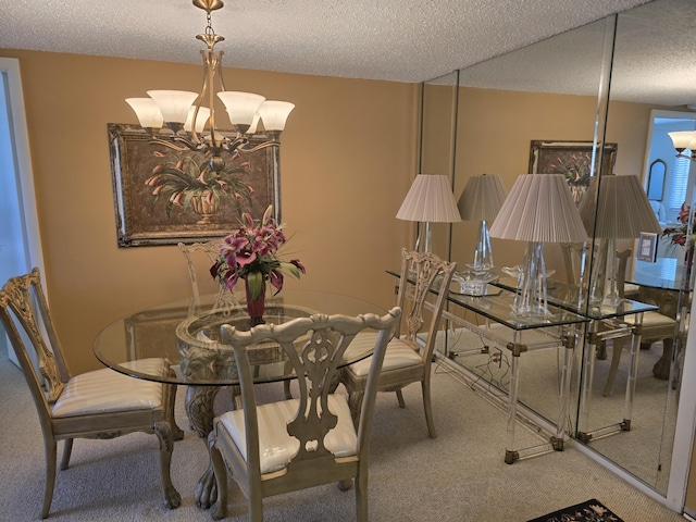 dining area featuring carpet flooring, a textured ceiling, and a notable chandelier