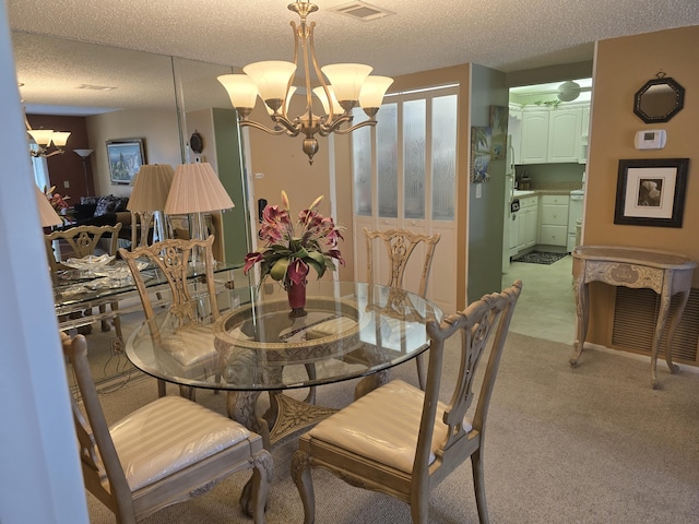 dining area featuring a textured ceiling, light carpet, and a chandelier