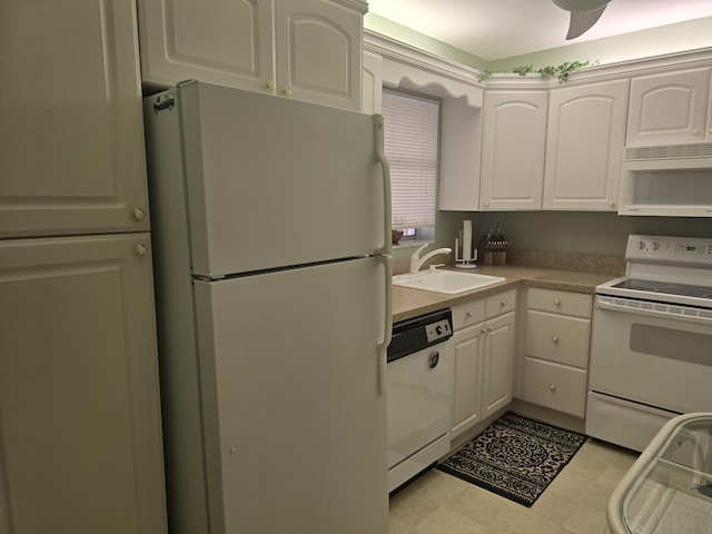 kitchen with white appliances, white cabinetry, and sink