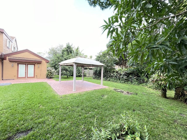 view of yard with a gazebo, french doors, and a patio