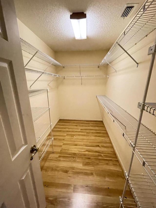 spacious closet featuring hardwood / wood-style floors