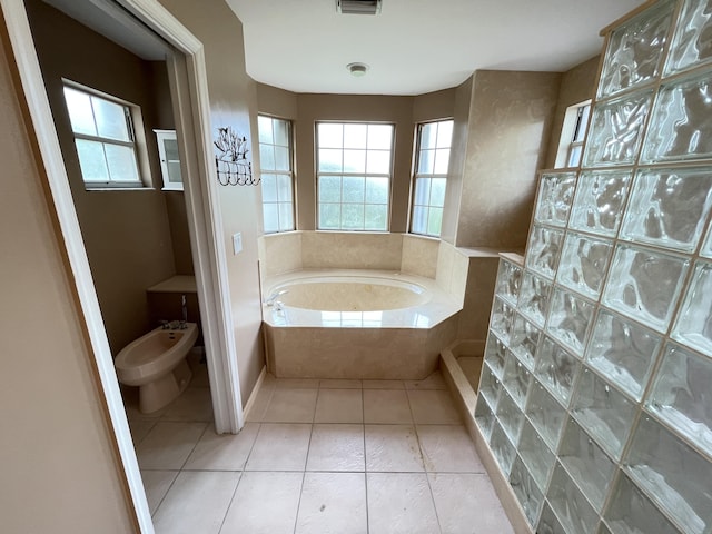 bathroom with tile patterned flooring, separate shower and tub, and a bidet