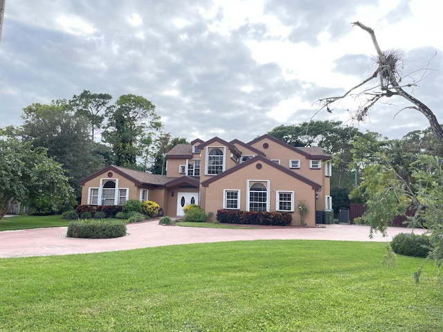 view of front of house featuring a front yard and central air condition unit