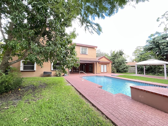 view of swimming pool with a gazebo and a yard