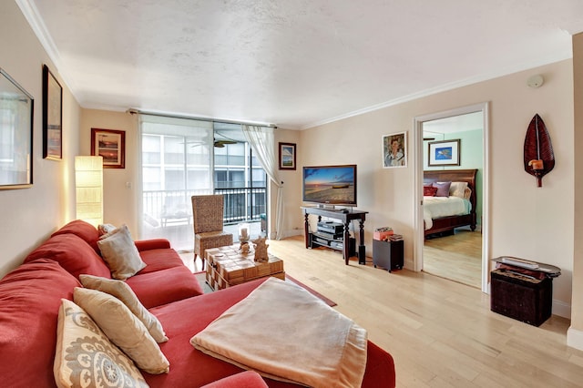 living room with light wood-type flooring and crown molding