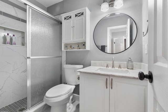 bathroom with an enclosed shower, vanity, and toilet