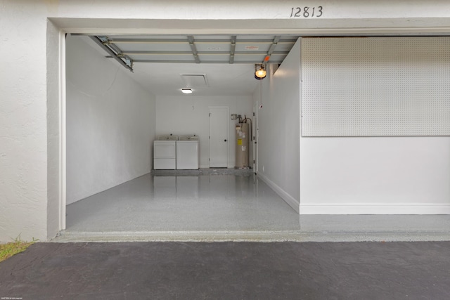 garage featuring gas water heater and independent washer and dryer