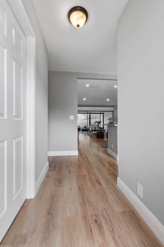 hallway with light hardwood / wood-style flooring