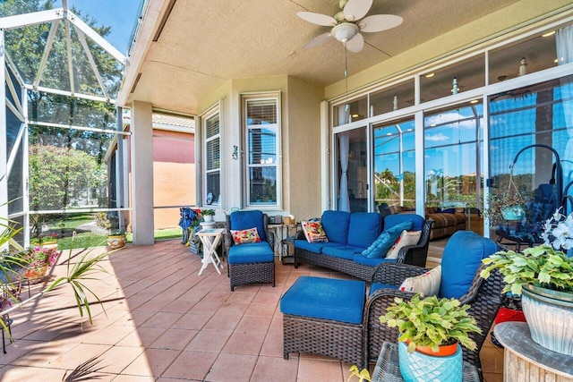 view of patio / terrace with glass enclosure, ceiling fan, and an outdoor hangout area