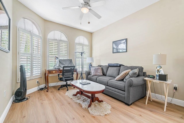 living room with light hardwood / wood-style floors, plenty of natural light, and ceiling fan