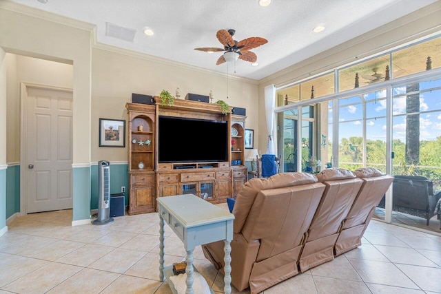 living room featuring ceiling fan, a healthy amount of sunlight, light tile patterned flooring, and crown molding