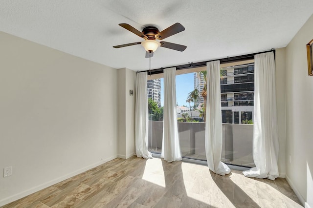 4200 N Ocean Dr Unit 2-202, Singer Island, FL 33404 - spare room with ceiling fan, baseboards, and a textured ceiling