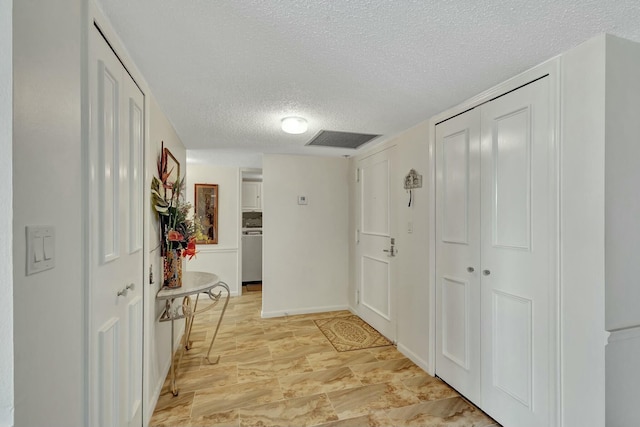 hallway featuring a textured ceiling