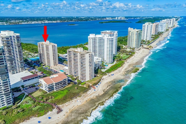 birds eye view of property with a water view and a view of the beach