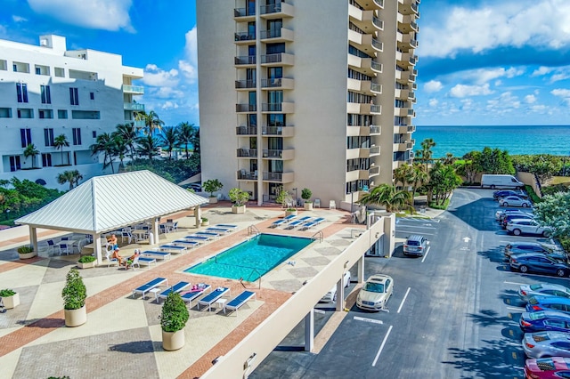 view of pool featuring a gazebo, a patio, and a water view