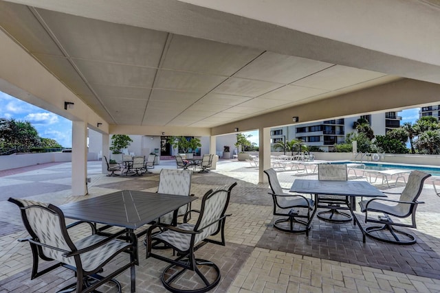 4200 N Ocean Dr Unit 2-202, Singer Island, FL 33404 - view of patio / terrace featuring outdoor dining area and a community pool