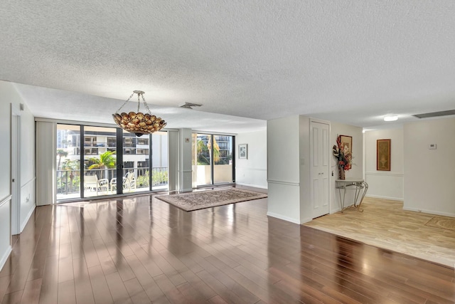4200 N Ocean Dr Unit 2-202, Singer Island, FL 33404 - spare room with a textured ceiling, wood finished floors, and baseboards