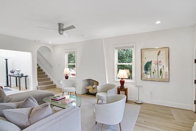 living room with ceiling fan, light hardwood / wood-style flooring, and a healthy amount of sunlight