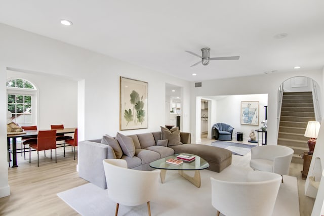 living room with ceiling fan and light wood-type flooring