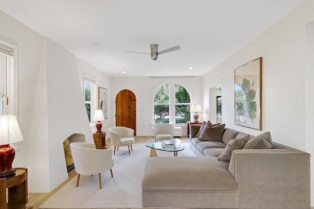 living room with ceiling fan and light hardwood / wood-style flooring