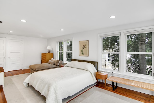 bedroom featuring multiple windows and hardwood / wood-style flooring