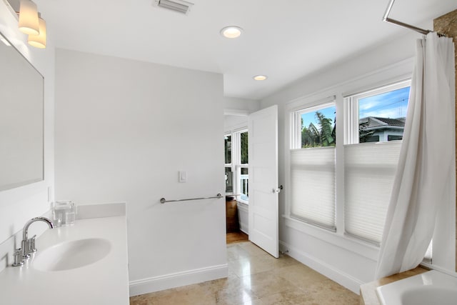 bathroom featuring tile patterned flooring, shower / bath combo, and vanity