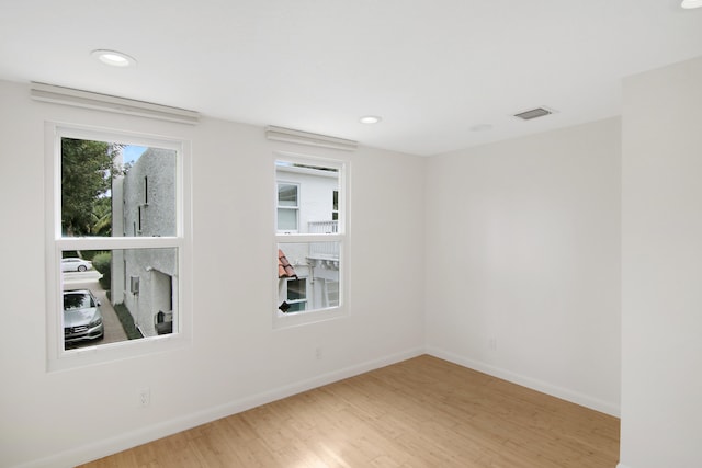 empty room with hardwood / wood-style floors