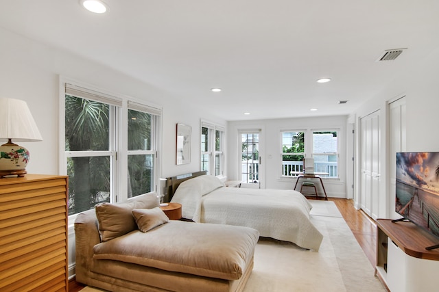 bedroom with access to outside and light hardwood / wood-style floors