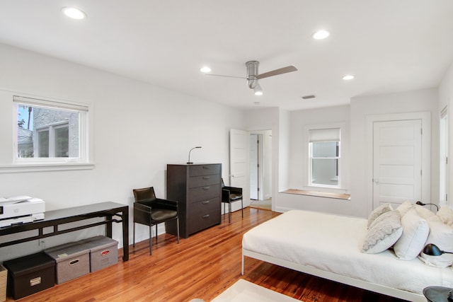 bedroom with ceiling fan and hardwood / wood-style flooring