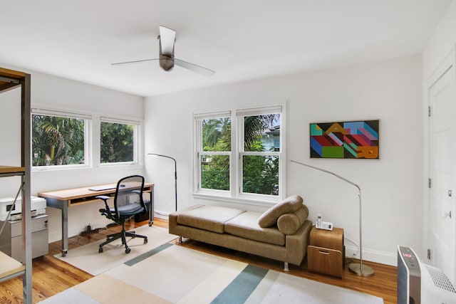 office space with light wood-type flooring and ceiling fan