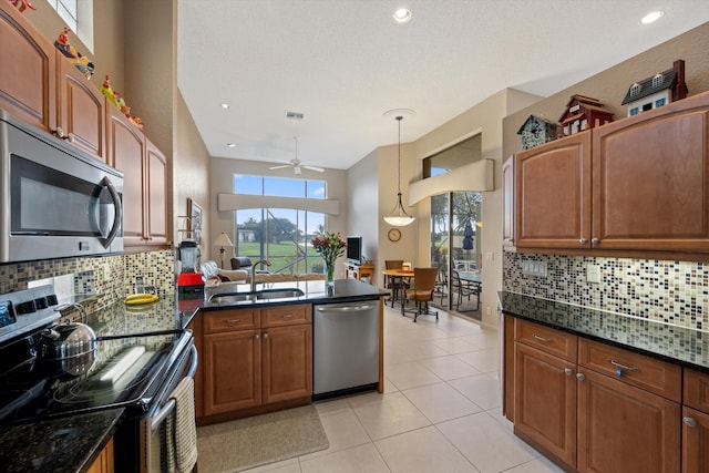 kitchen featuring sink, ceiling fan, decorative light fixtures, light tile patterned flooring, and stainless steel appliances