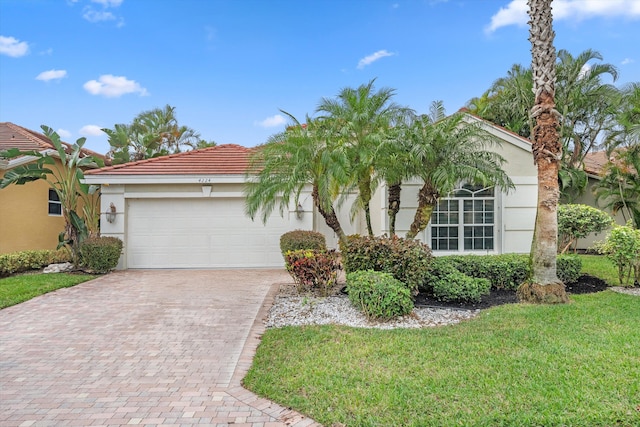 view of front of home featuring a garage and a front lawn