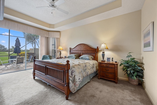 bedroom featuring access to outside, ceiling fan, light carpet, and a textured ceiling