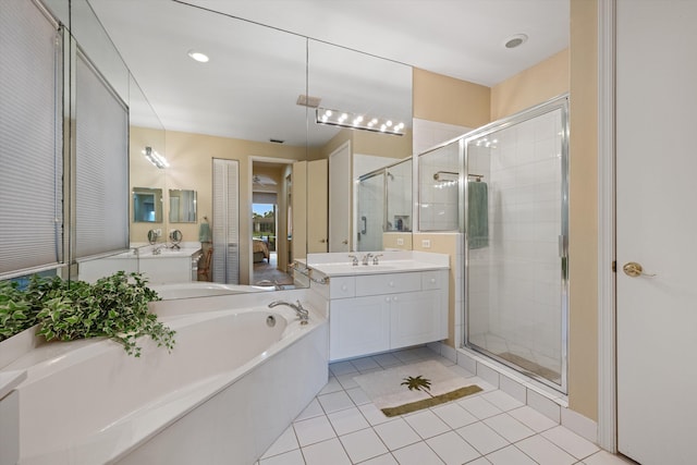 bathroom with tile patterned flooring, vanity, and plus walk in shower