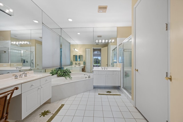 bathroom featuring tile patterned flooring, vanity, and shower with separate bathtub