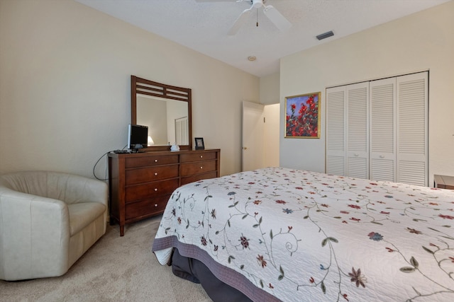 bedroom with ceiling fan, a closet, and light carpet