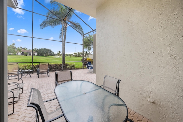 view of patio with glass enclosure