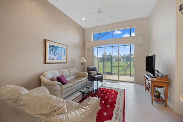 tiled living room featuring high vaulted ceiling, ceiling fan, and a healthy amount of sunlight