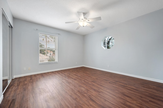 spare room featuring ceiling fan and dark hardwood / wood-style flooring