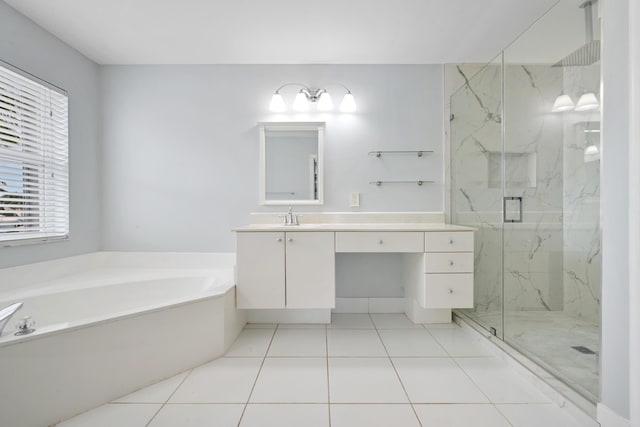 bathroom featuring plus walk in shower, vanity, a healthy amount of sunlight, and tile patterned flooring