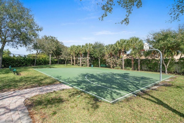 view of sport court featuring a yard