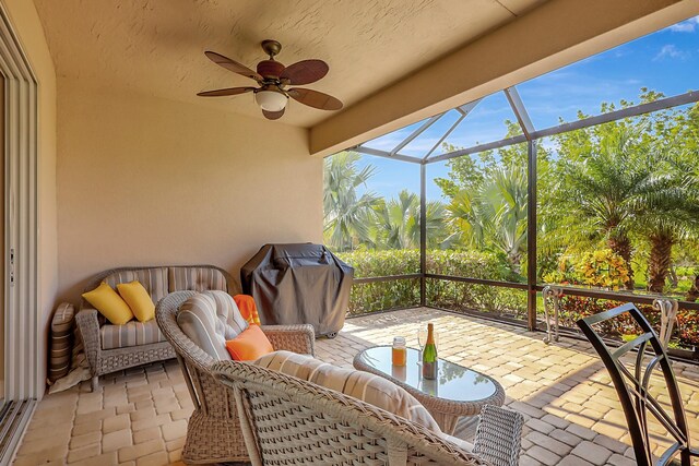 sunroom featuring ceiling fan