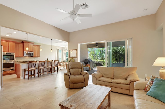 living room with light tile patterned flooring and ceiling fan