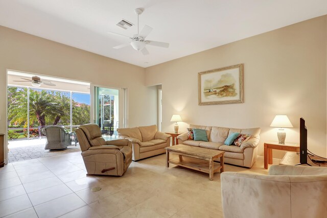 tiled living room with ceiling fan